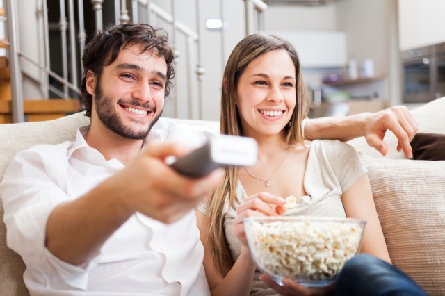 Young couple preparing to watch a movie